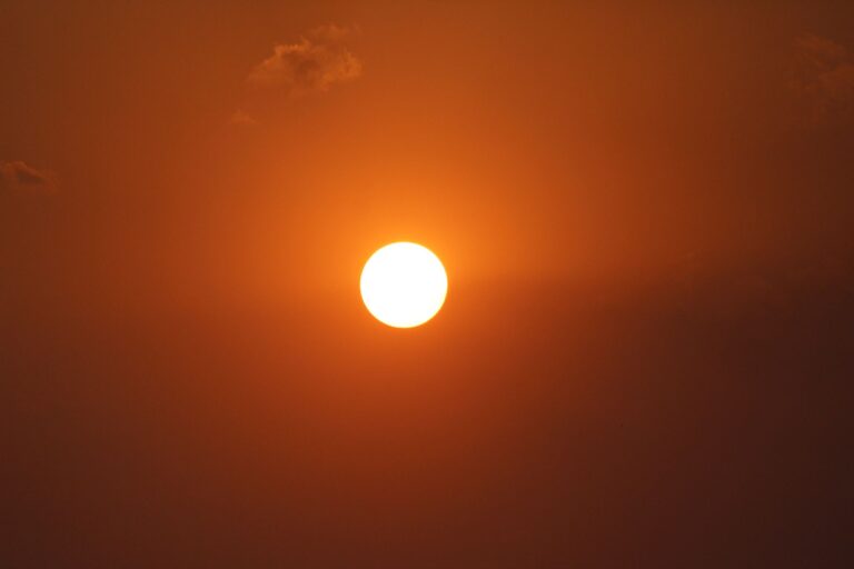 the sun across the orange sky